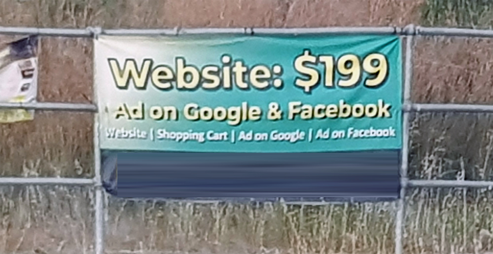 Photograph of roadside banner advertising cheap websites.
